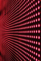 Vibrant abstract pattern of illuminated red LED lights forming a dynamic design.